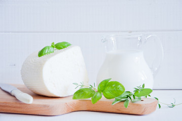 A variety of dairy products on white wood background