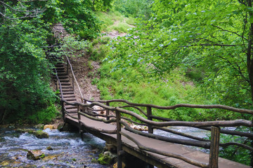 Save the environment, beautiful green park and forest with waterfall and small pure drinkable water creek, Romania, Bigar Cascade Falls, near Poneasca city, 04 June 2019