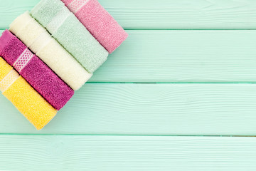 high quality cotton towels set on mint green wooden background top view mock up