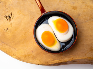 Children's toy skillet fried eggs on a wooden background isolation