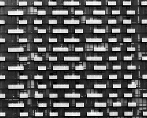 Fototapeta na wymiar Abstract Geometric Architecture Background. Facade of Modern Building with Balconies.