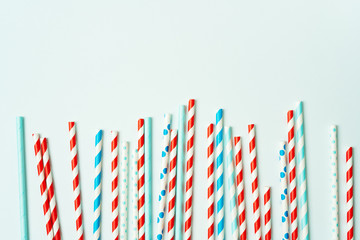 Colorful drinking straws for beverage on a bright background. Birthday festive cheerful background.