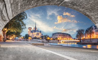 Notre Dame de Paris view from the Seine river with no people at sunset. View from under the bridge...