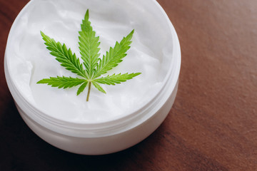 Cannabis oinment natural product. Cosmetic cream from natural hemp, moisturizing lotion with CBD content. Copy space for your design