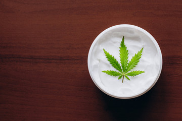 Cosmetic cream made of natural cannabis, hemp, moisturizing lotion with CBD content. Copy space for your design use,text