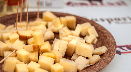 pieces of cheese on a plate with toothpicks