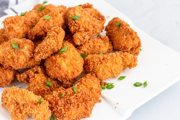 Chicken Nuggets on a Plate Served with Red Sauce on White Background. Popular American Fried Food, Snack, Fast Food, .Fried Chicken Dish..