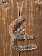 Transparent dental retainer or clear retainer, braces. Invisible aligner on the table wooden