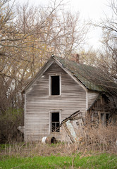 Old vintage weathered and abandoned house on the prairie