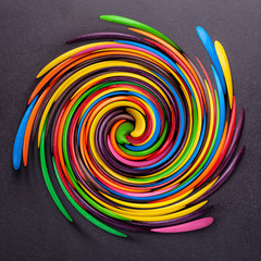 Multicolored bright positive windmill spiral of sweets, children's rainbow background texture for graphic design and text