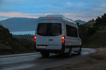 Minibus moves along the mountain winding road to the sea
