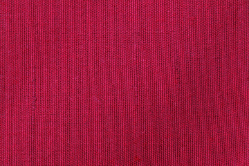 Red fabric background texture. Detail of textile material close-up