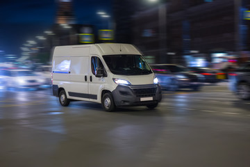 Obraz na płótnie Canvas Minibus Moves at Night Along City