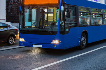Fototapeta na wymiar Passenger bus moves straight along city
