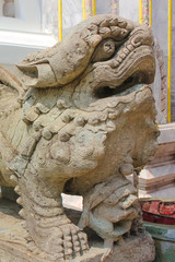 Fototapeta premium Detail of Lion guardian on Wat Phra Kaew, Temple of the Emerald Buddha at Bangkok.