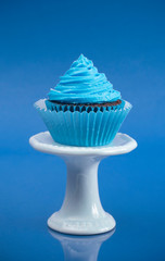 A Single Blue Cupcake on a Stand