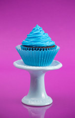 A Single Blue Cupcake on a Stand