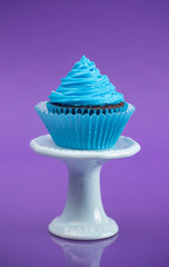 A Single Blue Cupcake on a Stand