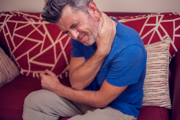 Man feels strong neck pain. People, healthcare and medicine concept