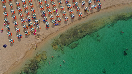 Aerial drone top view photo of turquoise organised beach forming a small heart shaped lagoon and mountainous seascape of Stavros, Chania, Crete island, Greece