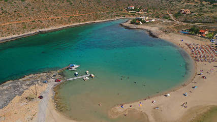 Aerial drone top view photo of turquoise organised beach forming a small heart shaped lagoon and mountainous seascape of Stavros, Chania, Crete island, Greece