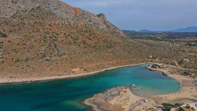 Aerial drone top view photo of turquoise organised beach forming a small heart shaped lagoon and mountainous seascape of Stavros, Chania, Crete island, Greece