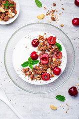 Yogurt with Cherries, Granola and Chia Seeds over Bright Background