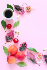 Coffee with fruits and follies on pink background. Top view with copy space. Flet lay style. Summer concept. © Ale02