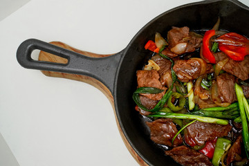 frying pan with meat and vegetables