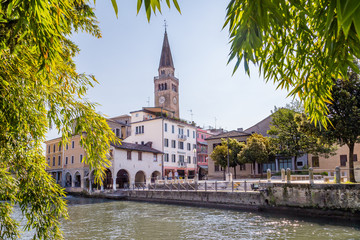 Portogruaro, Veneto Italy - May 22, 2019:  Cityscape of Portogruaro with  Dome Sant Andrea  and Lemene river