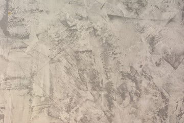Texture of uneven plastered gray wall. Abstract light background. Putty with stains and roughness. The basis for the layout or site.