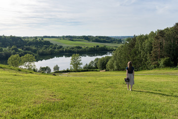 Woman enjoying time relaxing by the beautiful lake in the area of the Kashubian Landscape Park. Poland, Europe