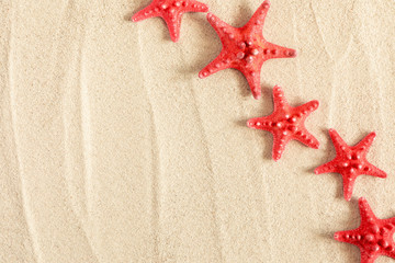Summer concept. Starfish on sea sand. Texture light sand. Concept  beach holiday. Flat lay, top view, copy space