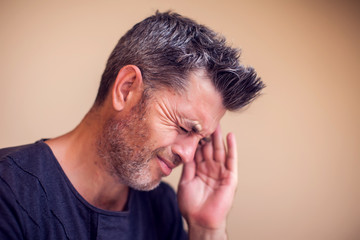 Fototapeta premium Man feels headache isolated. People, healthcare and medicine concept