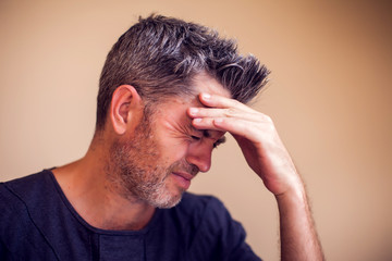 Fototapeta premium Man feels headache isolated. People, healthcare and medicine concept