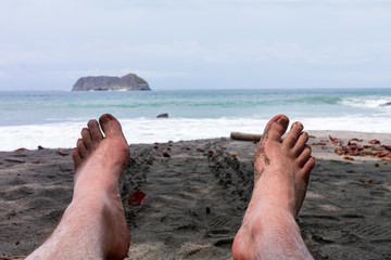 Looking over feet on beach