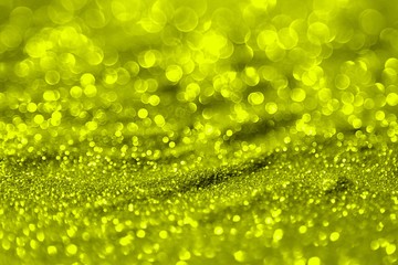 yellow shining aluminium sand made of glitters - bright concept with bokeh texture - cute abstract photo background