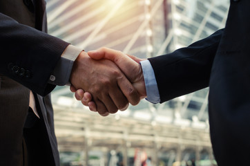Partnership. close up business man in modern suit hands shaking after finishing up a business meeting in the city, congratulation, success, meeting, partner, handshake, teamwork and connection concept - obrazy, fototapety, plakaty