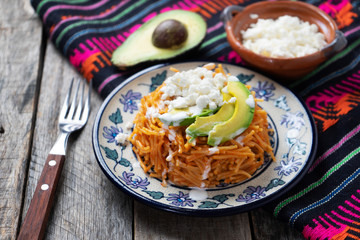 Mexican fideos dry soup with avocado and cheese