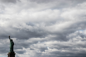statue of liberty against cloudy sky