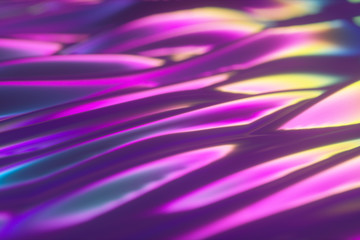 Abstract holographic oil surface background, foil wavy surface, wave and ripples, ultraviolet modern light, neon blue pink spectrum colors, 3d render graphic design, 3d illustration