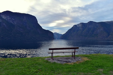 Naklejka na ściany i meble Sitting on a bench, resting and enjoying the most beautiful views of Norway 