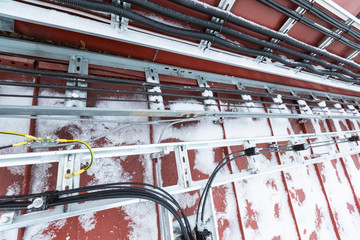Cable tray outside with telecommunications cables, optic fiber, power cables and transmitter data...