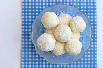 Homemade unbaked coconut balls in a glass bowl