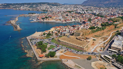 Aerial drone panoramic view of iconic and picturesque Venetian old port of Chania with famous landmark lighthouse and traditional character, Crete island, Greece