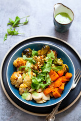Salad of warm roasted vegetables, cauliflower, brussel sprouts, butternut squash and beans with green dressing