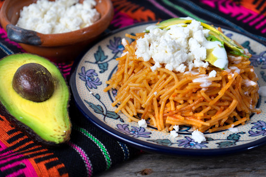 Mexican fideos dry soup with avocado and cheese