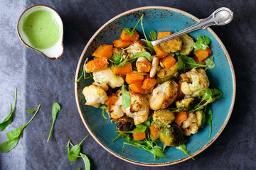 Salad of warm roasted vegetables, cauliflower, brussel sprouts, butternut squash and beans with green dressing