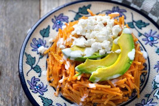 Mexican fideos dry soup with avocado and cheese