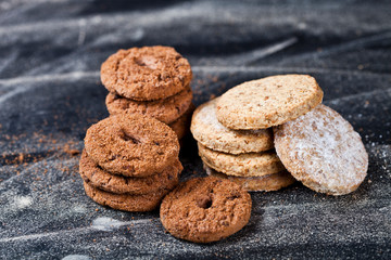 Fototapeta na wymiar Chocolate chip and oat fresh cookies with sugar powder stacks